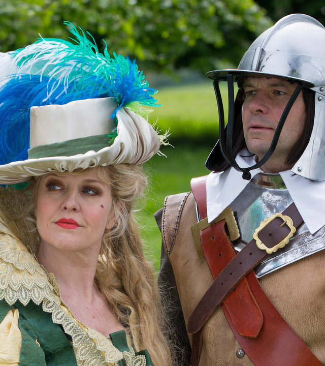 "Agatha Raisin – Und das Geisterhaus Teil 2": Agatha Raisin (Ashley Jensen) verkleidet als Dame zu Zeiten des Englischen Bürgerkriegs und James Lacey (Jamie Glover) verkleidet als Ritter stehen auf der Festwiese.