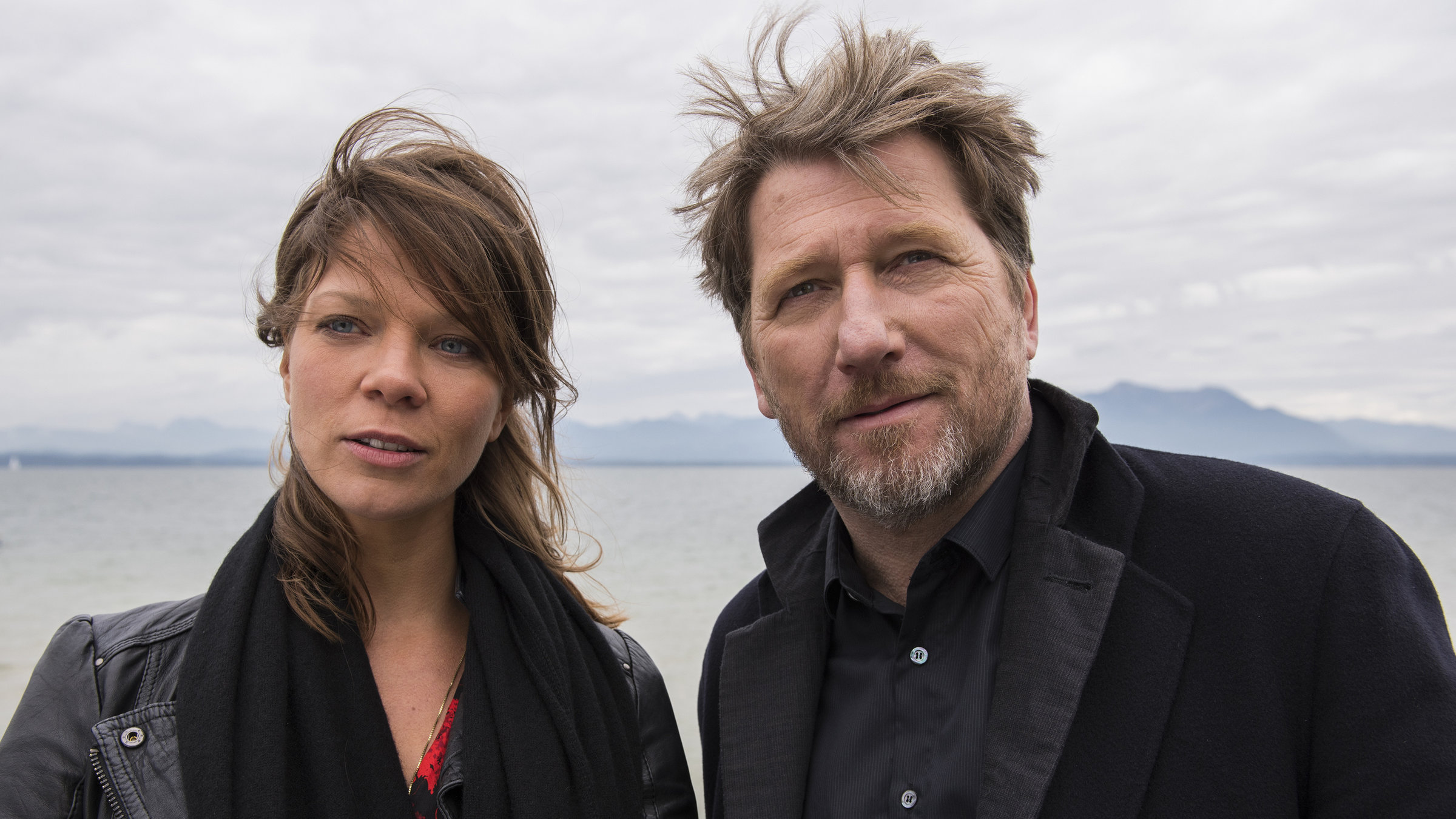 "Hattinger und der Nebel": Alfons Hattinger (Michael Fitz) und Sarah Beck (Jessica Schwarz) stehen auf einem Steg am Meer und blicken in die Ferne.