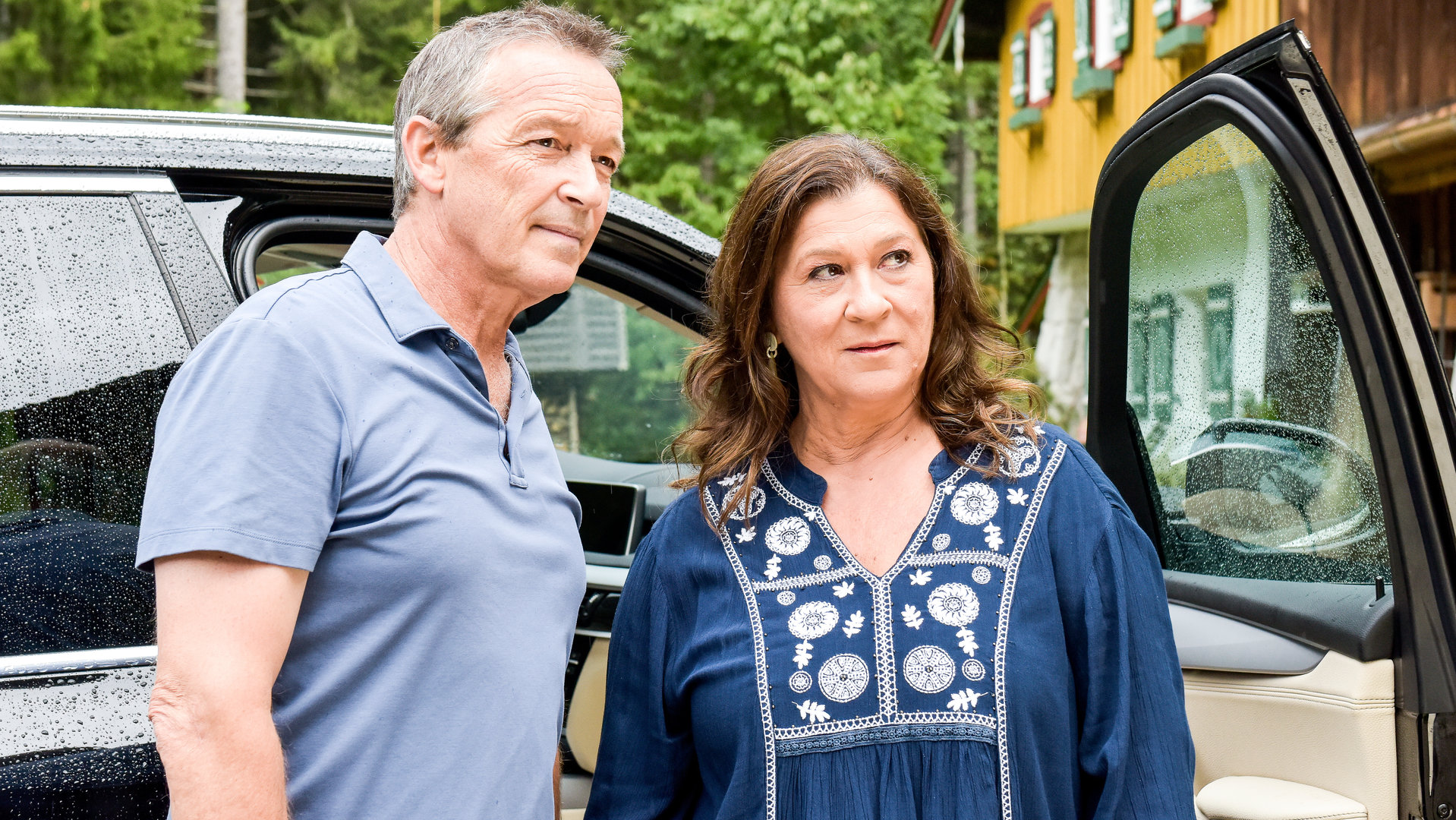 "Lena Lorenz - Geschwisterliebe (2)": Vor einer geöffneten Autotür stehen Eva Lorenz (Eva Mattes) und Vinz Huber (Michael Roll).