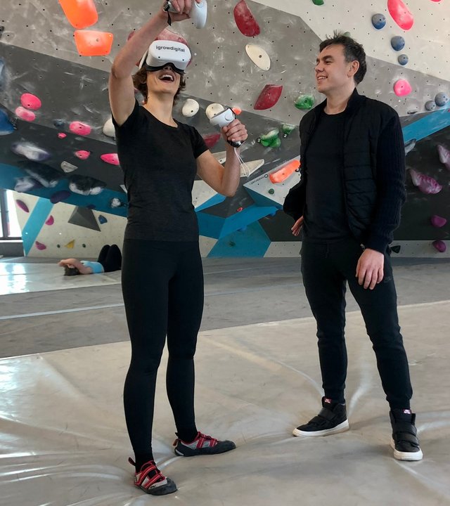 "Terra Xpress: Selbstoptimierung - Lust und Last": Lena Ganschow steht mit einer VR-Brille in einer Kletterhalle neben einem Mann.