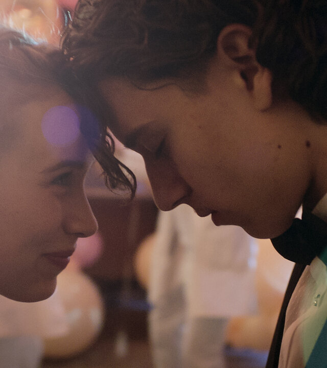 "Doktor Ballouz - Abschlussball": Juna (Lina Hüesker) blickt Ronni (Marven Gabriel Suarez-Brinkert) verliebt an. Die beiden haben ihre Köpfe aneinander gelegt.