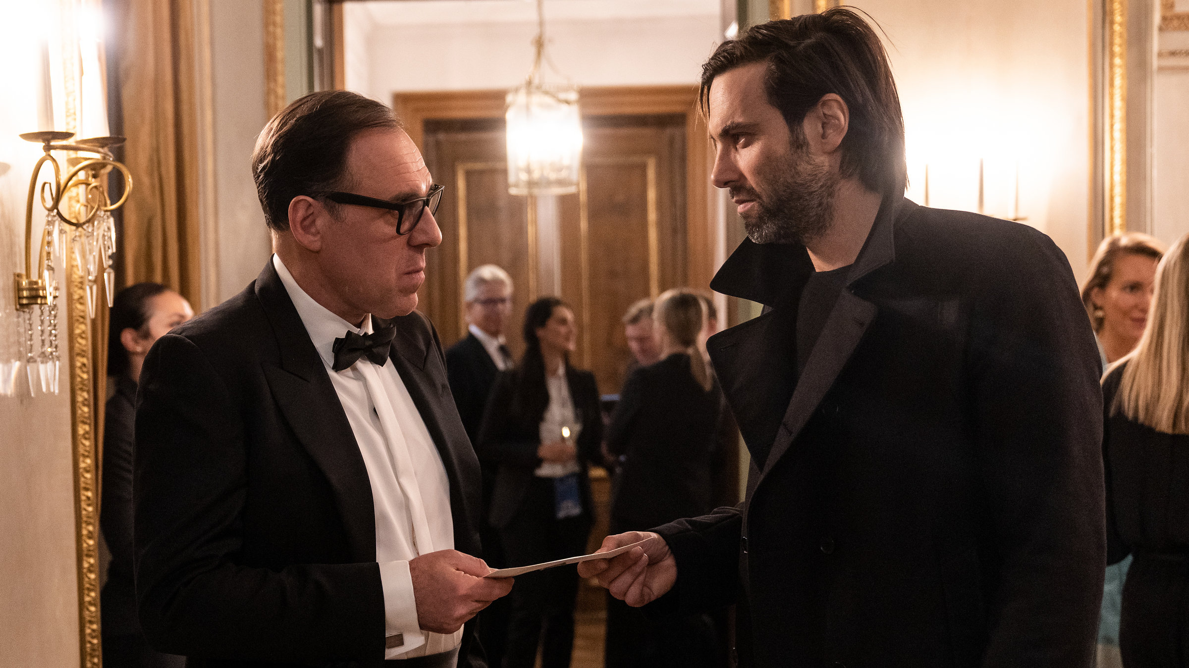 "Laim und das Hasenherz": Lukas Laim (Max Simonischek) übergibt Maximilian Kronberger (Thomas Loibl) einen Umschlag.