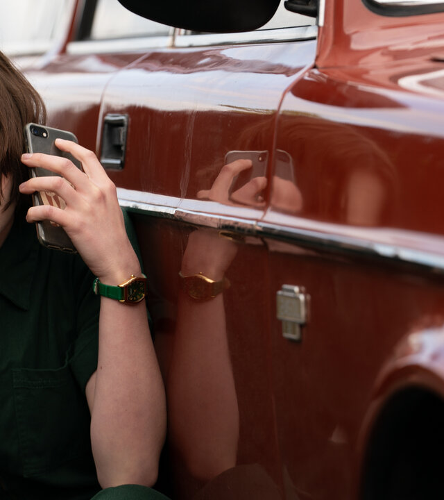 "A Good Girl’s Guide to Murder – Vielleicht kann man gar nicht gut sein": Pip Fitz-Amobi (Emma Myers) hockt dicht neben ihrem roten Auto und hält ein Handy ans Ohr. Ihr Blick ist besorgt.