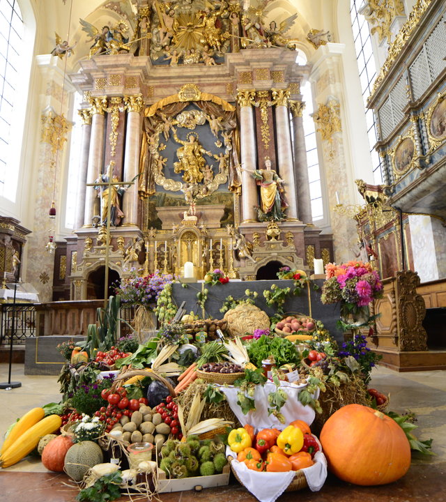 "Katholischer Gottesdienst - Danke sagen": Blick ins Innere der Pfarrkirche Mariä Himmelfahrt in Feichten an der Alz und auf den Altar mit den Erntedankgaben.