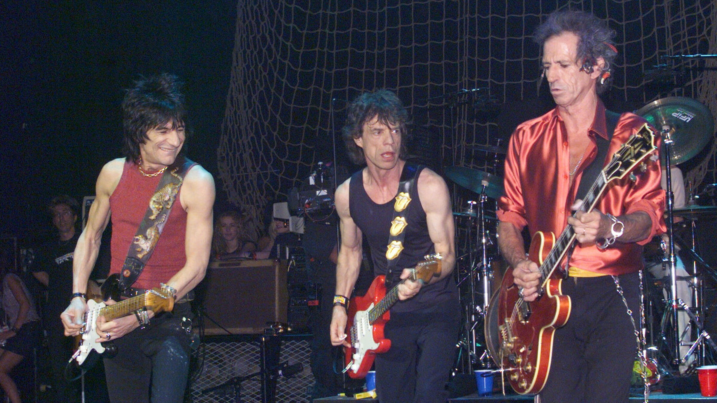 "The Rolling Stones: Welcome to Shepherd’s Bush": Die Bandmitglieder (v.l.n.r.) Ron Wood, Mick Jagger und Keith Richards stehen nebeneinander auf der Bühne. Alle halten eine E-Gitarre in der Hand.