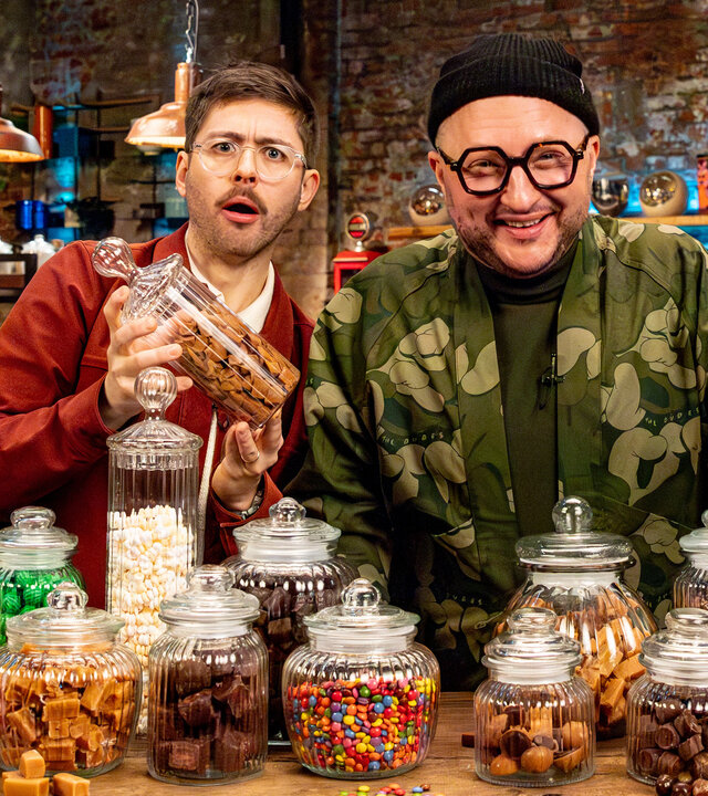 "besseresser: Das Duell - Wer macht's besser? Sahne Muh-Muh, Twix und Toffifee": Produktentwickler Sebastian Lege und Host Florian Reza stehen hinter einem Tisch, auf dem jede Menge Gläser mit Süßigkeiten stehen.