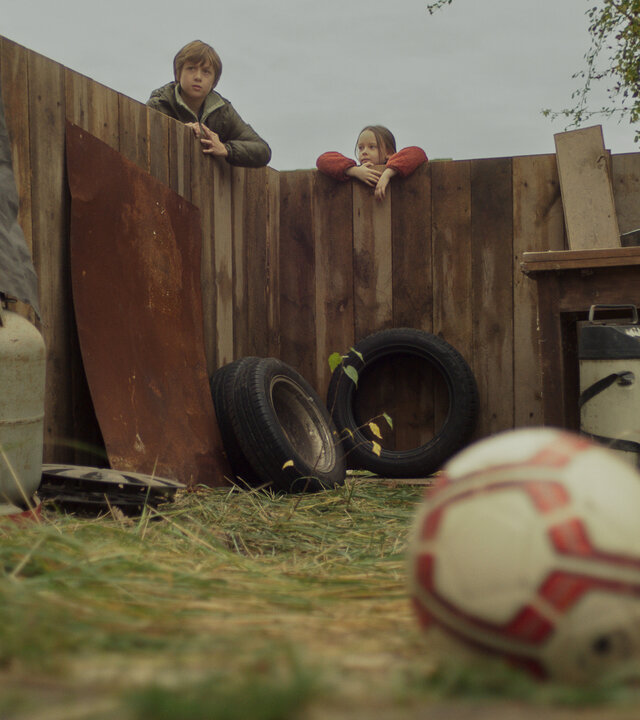 "Doktor Ballouz - Helden": Daniel (Marian Dilger) und seine Schwester Zoé (Elise Lindner) blicken vom Zaun aus auf den Fußball, der auf dem Nachbarsgrund gelandet ist.