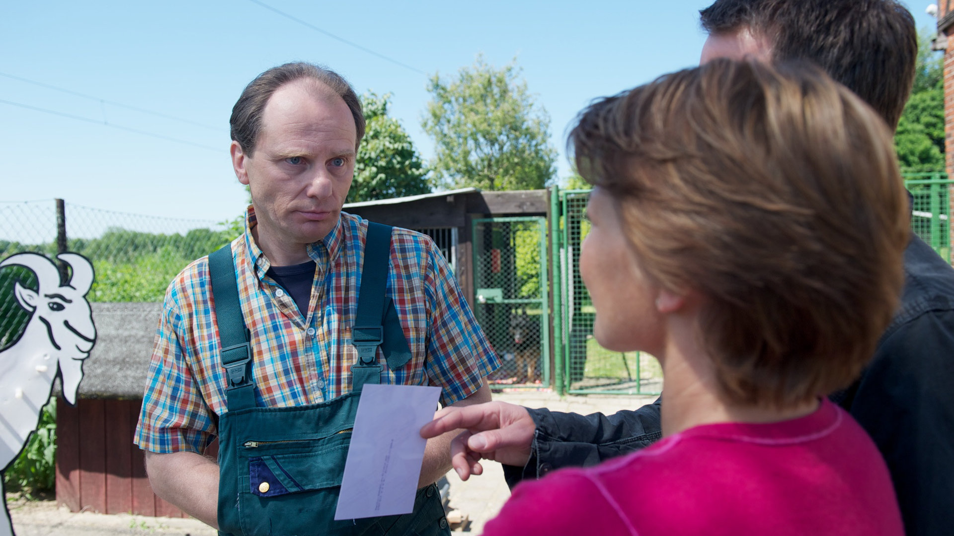 "SOKO Wismar - Muttertag": Tierheimleiter Rüttges (Christoph Hohmann) steht vor den Kommissaren Katrin Börensen (Claudia Schmutzler) und Sven Herzog (Michael Härle) und schaut Katrin Börensen an. Sven Herzog zeigt Rüttges ein Foto. Die drei befinden sich in einem Tierpark.