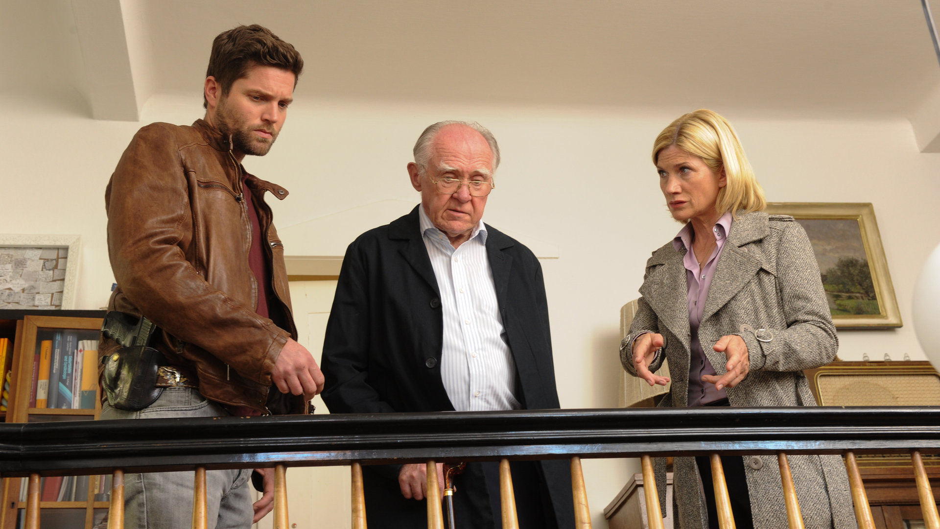 "SOKO Stuttgart - Dachschaden": Jo Stoll (Peter Ketnath), Dietrich Möller (Carl Heinz Choynski) und Martina Seiffert (Astrid M. Fündereich) stehen an einer Treppe. Die beiden Männer blicken nach unten, während Martina gestikulierend zu Möller schaut.