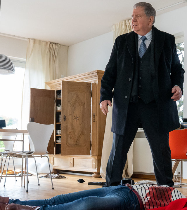 "Der Staatsanwalt - Spiel mit dem Feuer": Oberstaatsanwalt Bernd Reuther (Rainer Hunold) steht in einem Wohnzimmer neben der am Boden liegenden Leiche von Nathalie Kremp (Janina Rudenska).