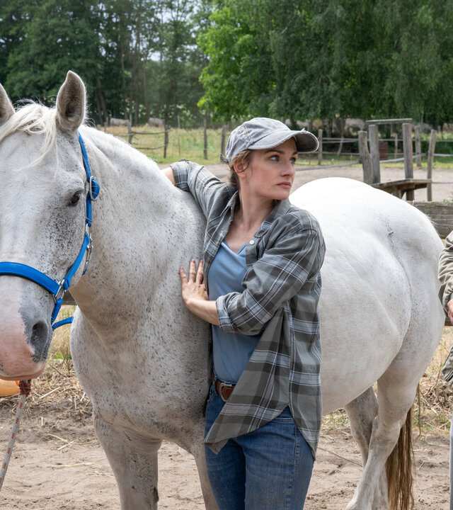 "SOKO Wismar – Miami, Ibiza, Wismar": Auf einer Pferdekoppel befragen die Kriminalkommissare Karoline Joost (Nike Fuhrmann) und Lars Pöhlmann (Dominic Boeer) die Ex-Freundin des verstorbenen DJs, Rebecca Bachmann (Karoline Teska), während sie ihr Pferd versorgt.