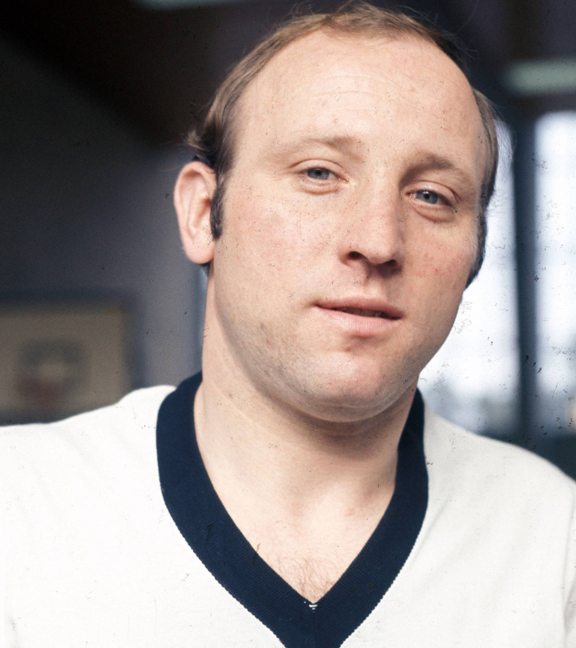 "Terra X History - "Uns Uwe" Seeler - Deutschlands Fußballheld". Uwe Seeler steht in einer Halle im Trikot der deutschen Fußballnationalmannschaft, er stützt seine Hände in die Hüften und blickt in die Kamera, 1970.