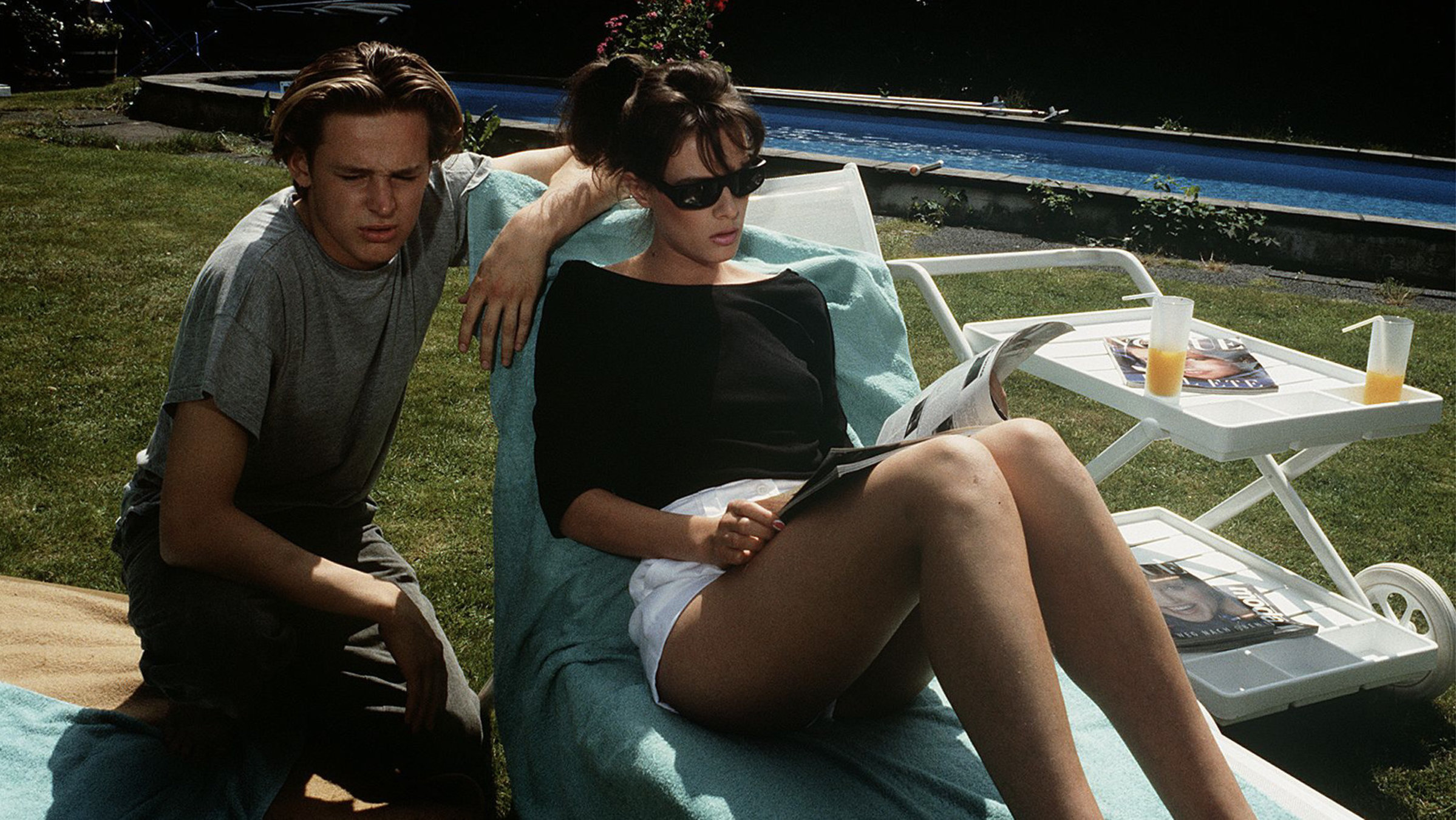 "Der Landarzt - Feiertage gibt es nicht": Eike Mattiesen (Hendrik Martz) lehnt seinen Arm an einer Sonnenliege, auf der Hilke (Svenja Pages) sich sonnt.