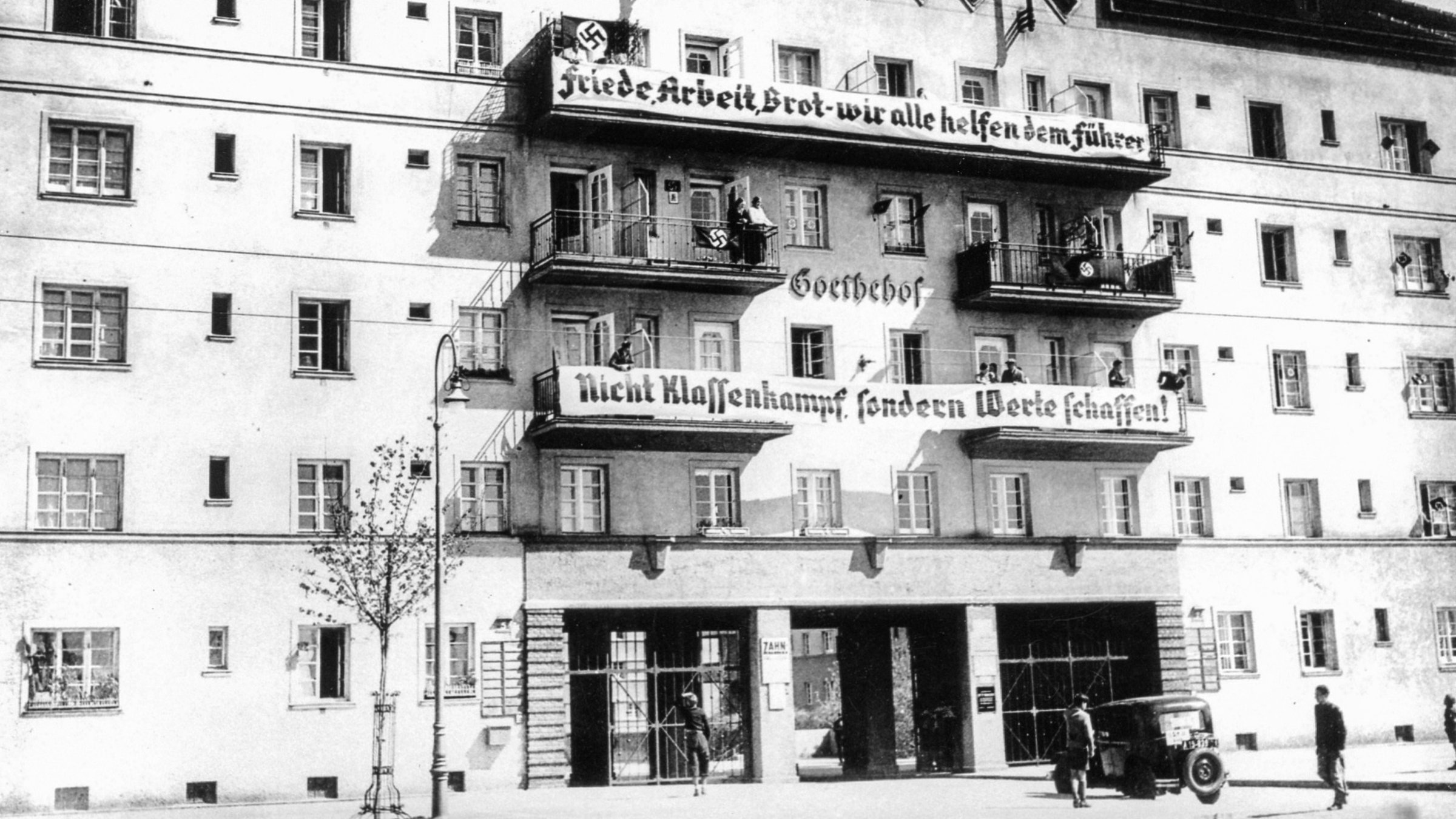 "Österreich I - Die Heimsuchung Österreichs" - NS-Parolen gegen den Klassenkampf auf den Wiener Gemeindebauten.