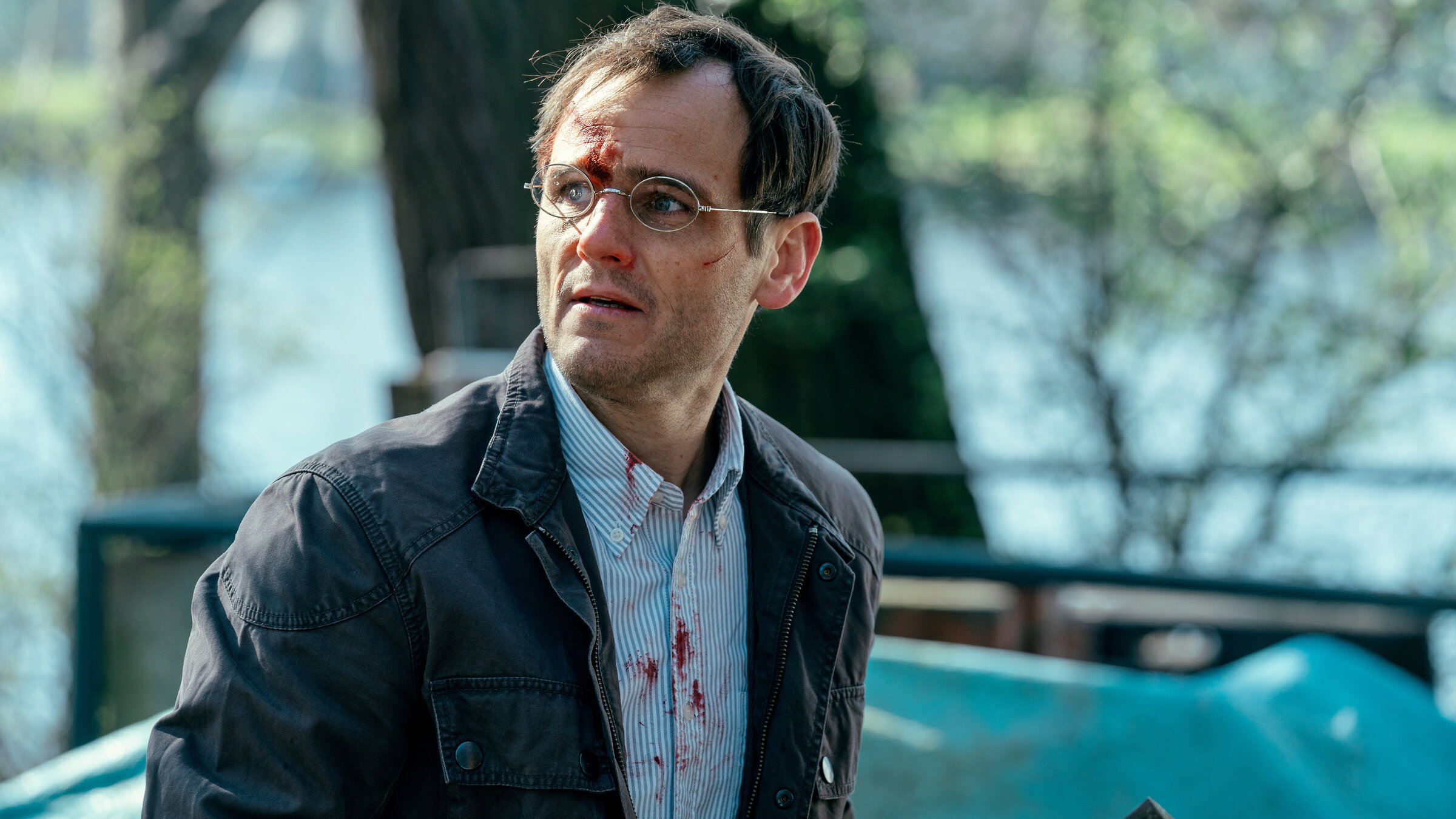 "Jenseits der Spree - Abserviert": Thorsten Reinhardt (Peter Sikorski) schaut sich fragend um. Er hat eine blutige Kopfwunde und seine Kleidung ist blutverschmiert.