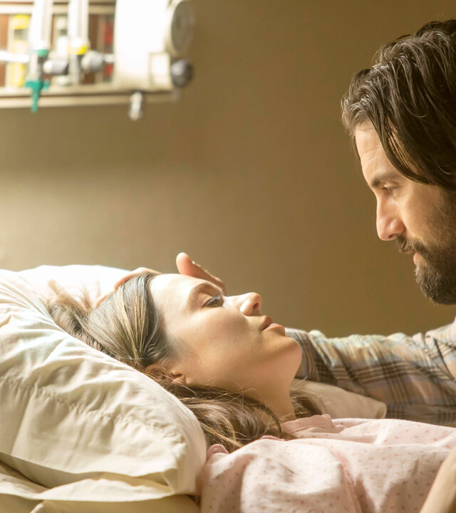 "This Is Us - Das ist Leben: Happy Birthday": Rebecca Pearson (Mandy Moore) liegt in einem Krankenhausbett und trägt ein Operationshemd. Jack Pearson (Milo Ventimiglia) sitzt bei ihr und legt ihr sanft eine Hand ans Gesicht. Beide blicken sich tief in die Augen.
