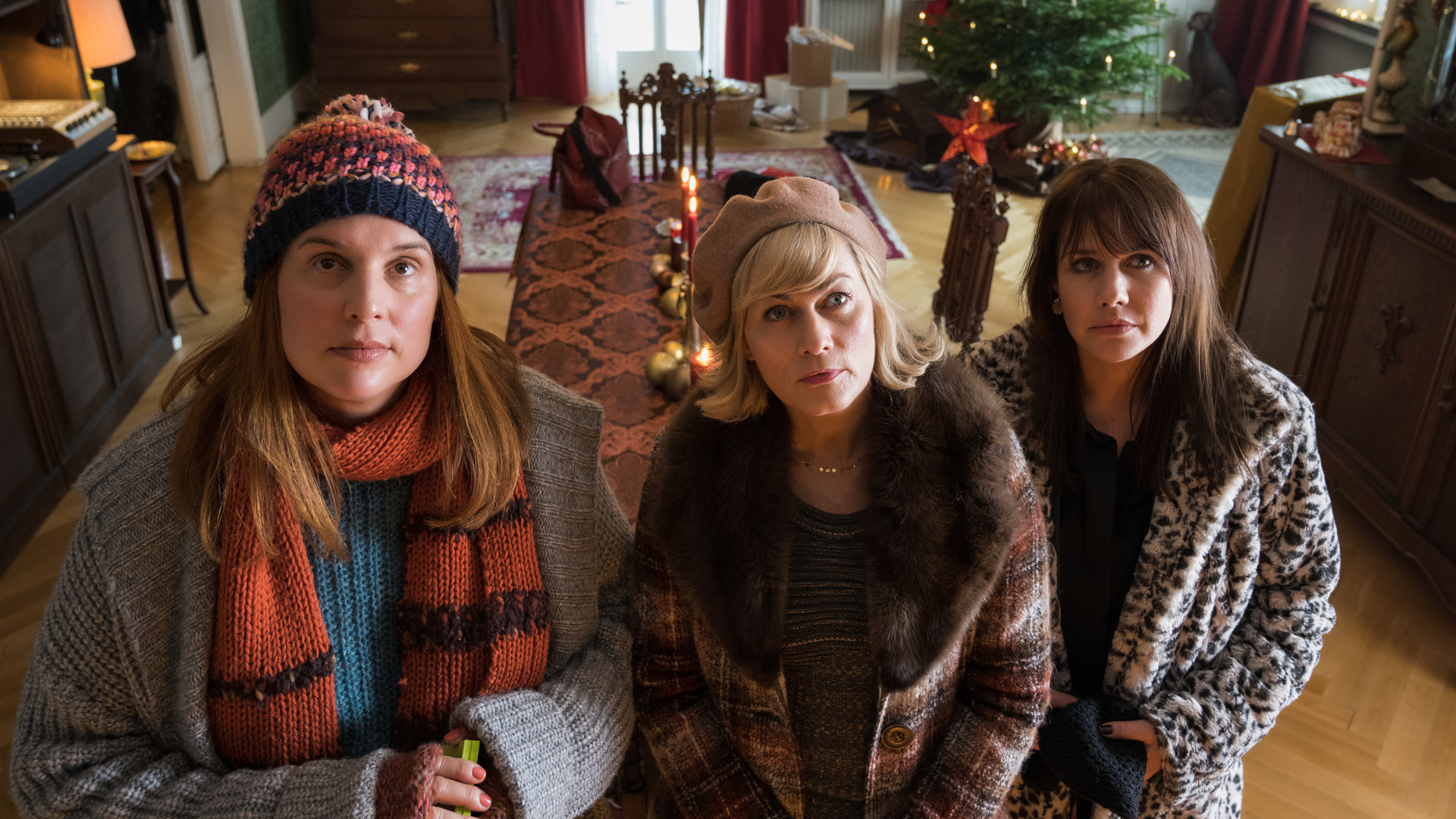 "Weihnachtstöchter": Katarina (Elena Uhlig), Regina (Gesine Cukrowski), Diana (Felicitas Woll) stehen im Wohnzimmer nebeneinander und schauen andächtig zum Portrait des gemeinsamen Vaters hoch.