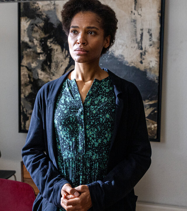 "Letzte Spur Berlin - Zugehörig": Jacky Steiner (Cynthia Micas) steht mitten in einem Büro mit zusammengefalteten Händen und schaut dabei sehr verzweifelt nach vorne.