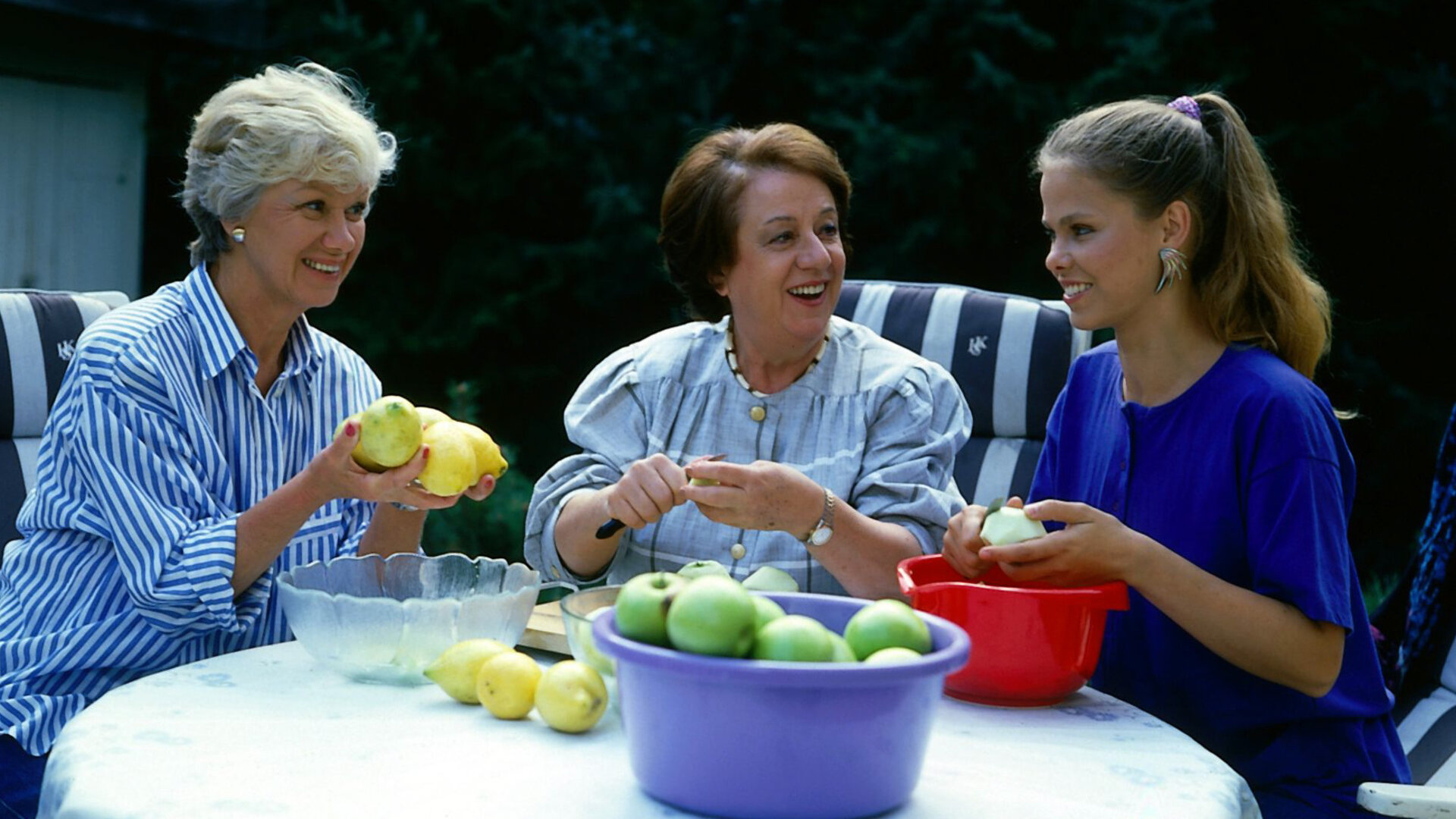 "Die Wicherts von nebenan: Einkochen und Einbrechen": An einem Gartentisch. Hannelore (Maria Sebaldt), Gerda (Inge Wolffberg) und Elke (Juliane Rautenberg) schälen in fröhlicher Stimmung gemeinsam Äpfel, um Kompott zu kochen.