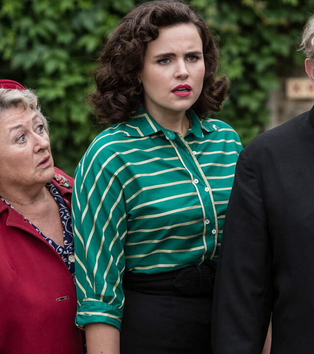 "Father Brown - Romeo und Julia": Mrs. McCarthy (Sorcha Cusack), Bunty (Emer Kenny) und Father Brown (Mark Williams) stehen leicht versetzt hintereinander und schauen besorgt nach vorn.
