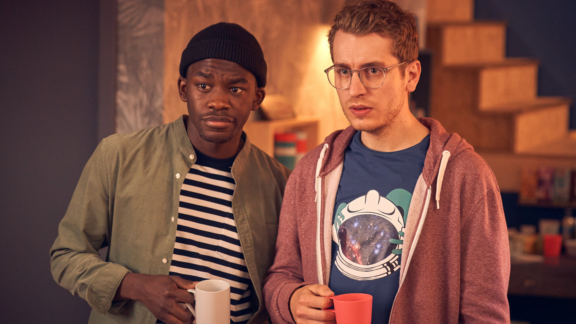 "Start the fck up - Fail Night": Kenny (Kelvin Kilonzo) und Jens (László Branko Breiding) stehen mit nachdenklichem Blick nebeneinander.
