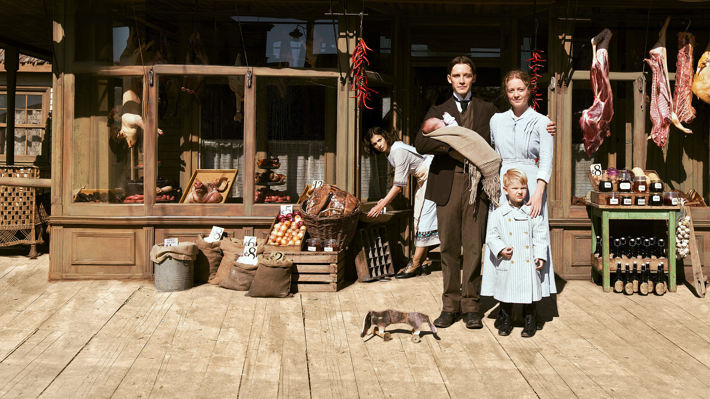 "Der Club der singenden Metzger (1/2)": Titel Presseheft - Neuanfang in Amerika: Fidelis Waldvogel (Jonas Nay) mit Ehefrau Eva (Leonie Benesch), ihrem Sohn (Mark Đurđević) und der deutschen Auswanderin Delphine (Aylin Tezel, hinten), die zur Familie gehört.
