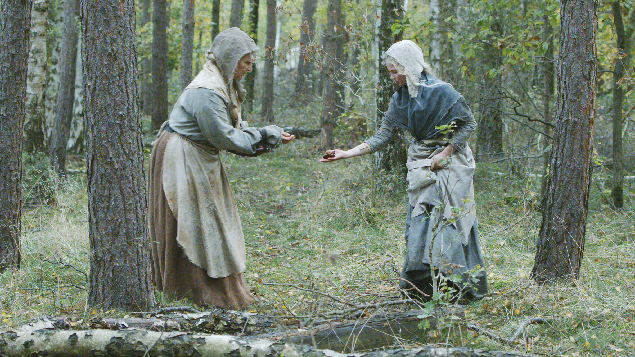 "Terra X: Eine kurze Geschichte über... Die Hexenverfolgung": Zwei Frauen in mittelalterlicher Kleidung stehen sich im Wald gegenüber.