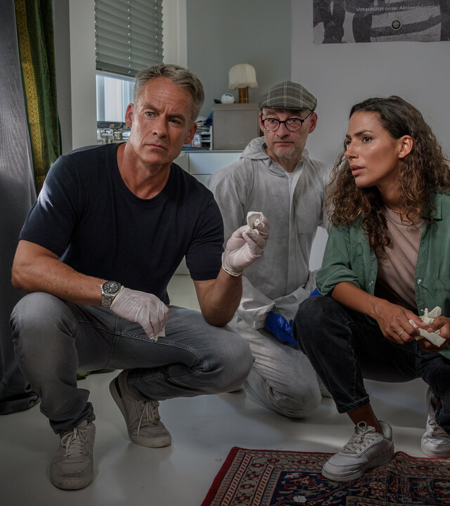 "SOKO Leipzig - Kowalski": Jan Maybach (Marco Girnth), Kriminaltechniker Spusi-Holger (Holger Koch) und Kim Nowak (Amy Mußul) sind in der Hocke in einer Wohnung. Sie sammeln Spuren.