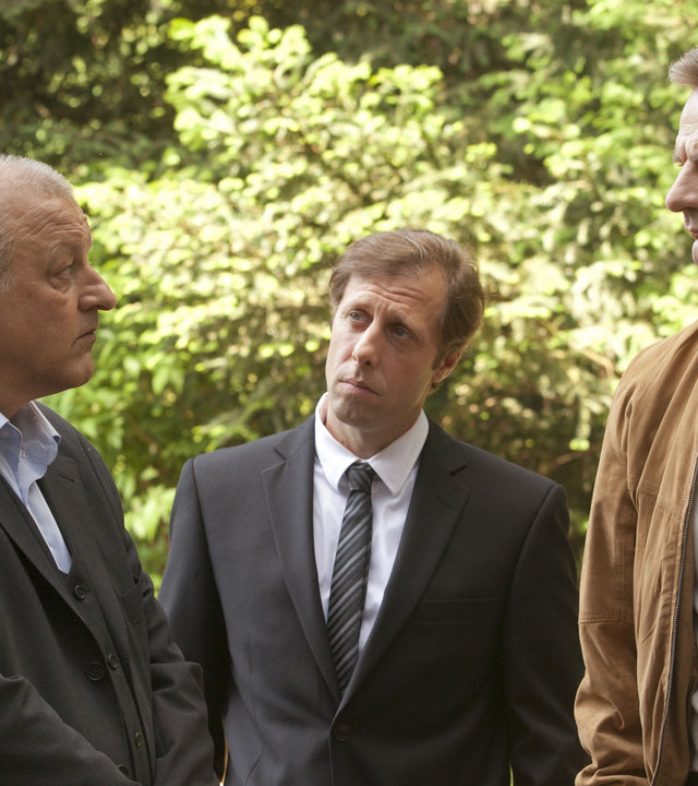 "Wilsberg - Die Bielefeld-Verschwörung": Wilsberg (Leonard Lansink), Ekki (Oliver Korittke) und Manni (Heinrich Schafmeister) stehen nebeneinander auf einem Friedhof.