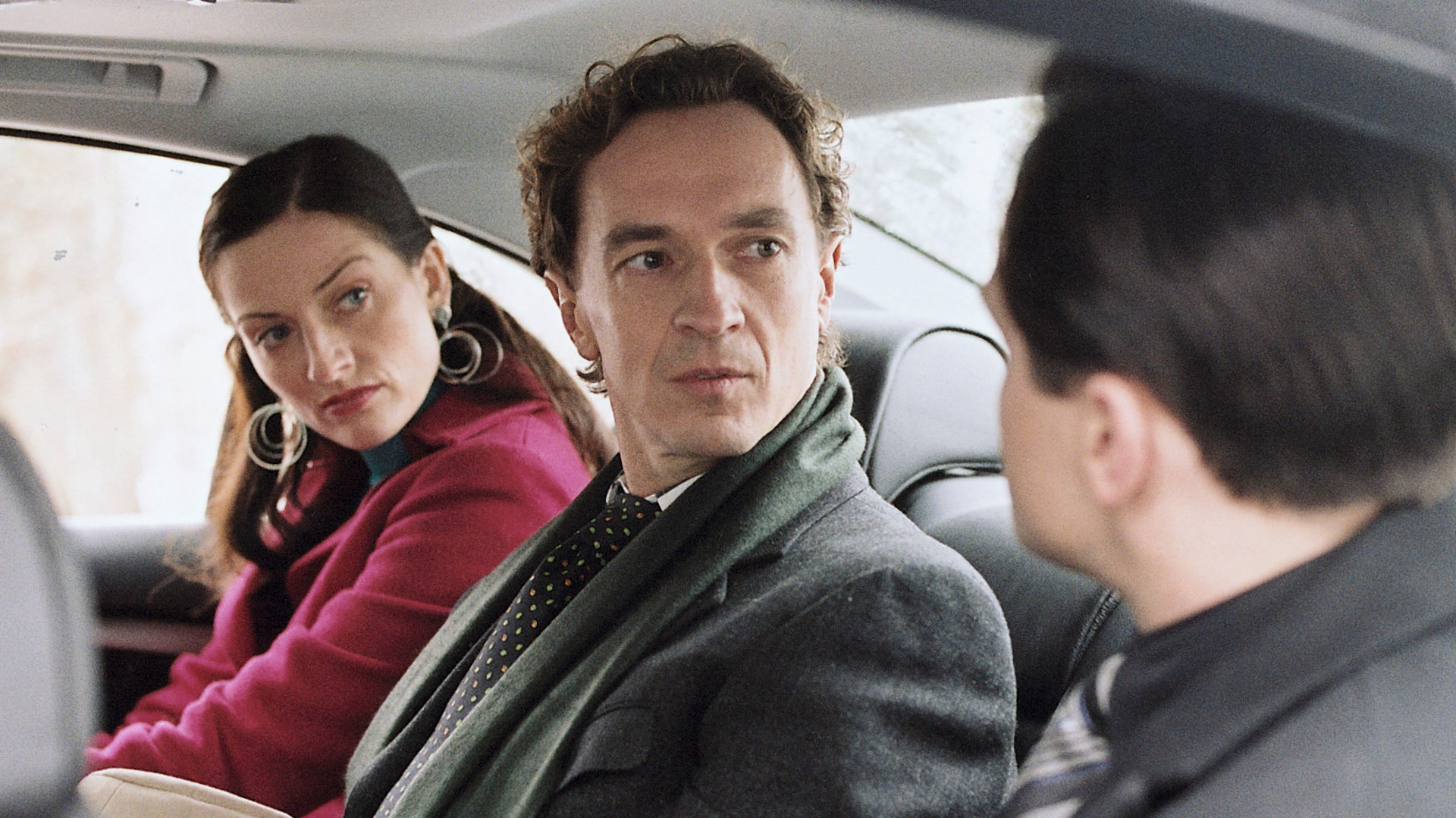 "Bianca - Wege zum Glück: Kapitel 128": In einem Auto: Geschäftspartner Heidenreich (Stephan Wapenhaus) sitzt zwischen Katy (Nicola Ransom) und Pascal (Michael Rotschopf). Er schaut irritiert in Pascals Richtung. Auch Katy schaut zu Pascal.