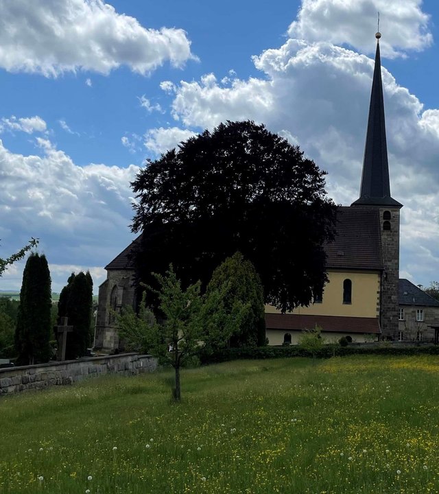 "Katholischer Gottesdienst - Gut versichert - mit Gott": Außenansicht auf die Kirche Heiligste Dreifaltigkeit in Marktgraitz.