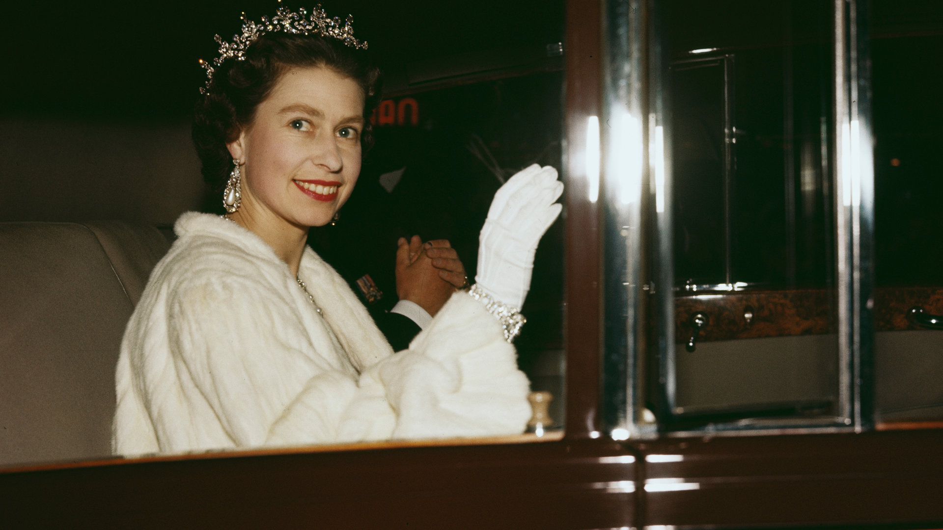 "Terra X History: Die Queen - Erinnerungen an eine Jahrhundertkönigin": Königin Elisabeth winkt aus einem Auto heraus, sie trägt einen weißen Mantel.